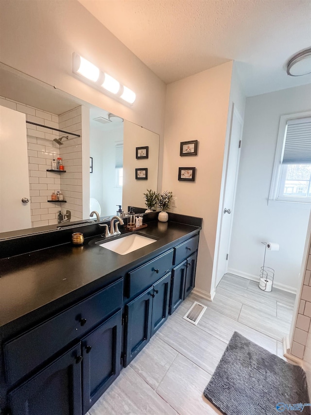 bathroom featuring vanity and a textured ceiling