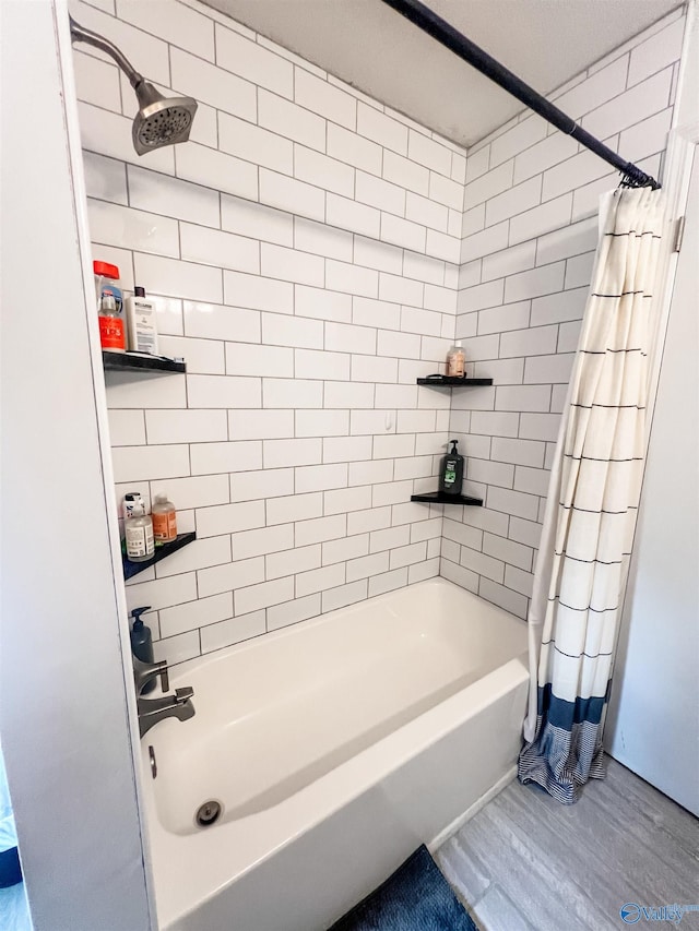 bathroom with hardwood / wood-style flooring and shower / bath combination with curtain