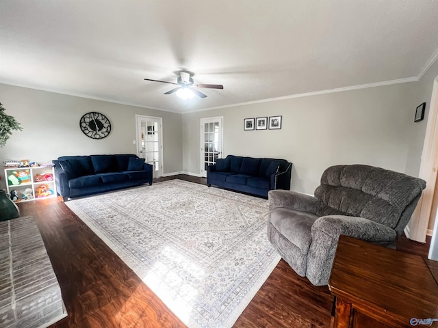 living room with wood-type flooring, ornamental molding, and ceiling fan