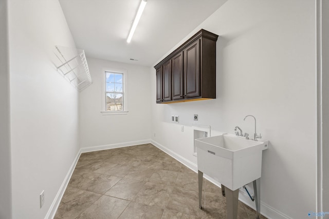 clothes washing area featuring cabinets, electric dryer hookup, and washer hookup