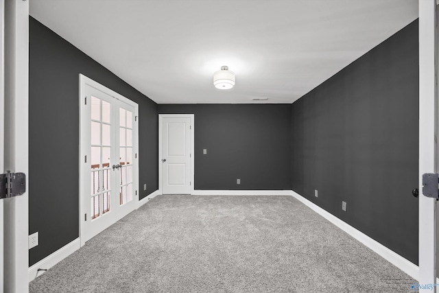 spare room featuring french doors and carpet flooring