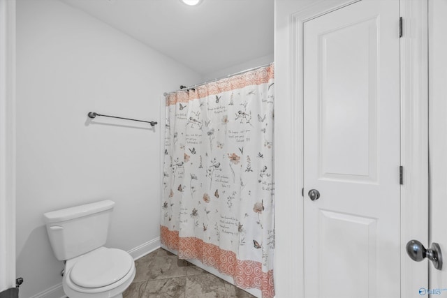 bathroom featuring tile patterned flooring, shower / bath combination with curtain, and toilet