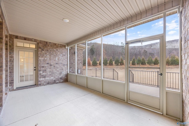 unfurnished sunroom with a mountain view