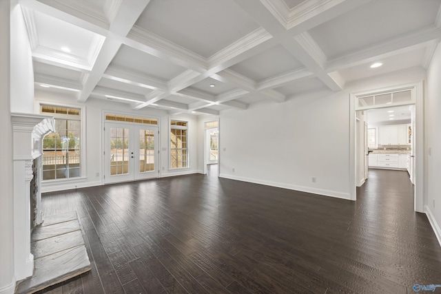 unfurnished living room with dark hardwood / wood-style flooring, ornamental molding, coffered ceiling, beam ceiling, and french doors