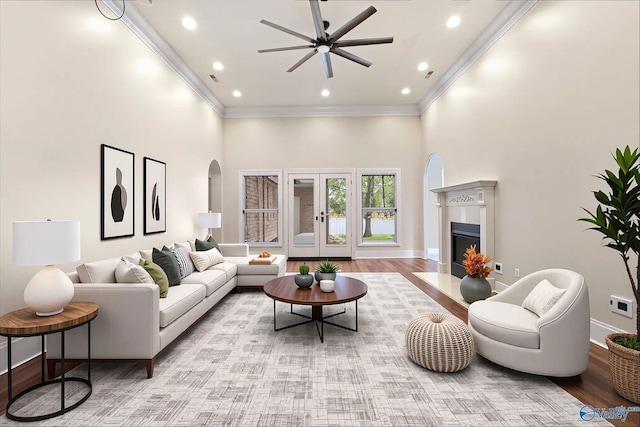 505 Barkley St SW, Hartselle, AL 35640 - living area with a towering ceiling, crown molding, ceiling fan, baseboards, and arched walkways
