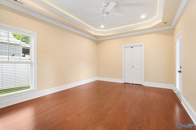 505 Barkley St SW, Hartselle, AL 35640 - spare room with dark wood finished floors, a raised ceiling, ceiling fan, baseboards, and crown molding