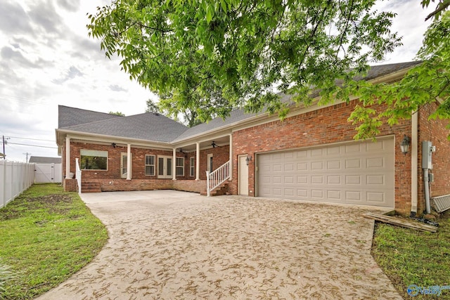 505 Barkley St SW, Hartselle, AL 35640 - view of front of house featuring a ceiling fan, brick siding, driveway, fence, and covered porch