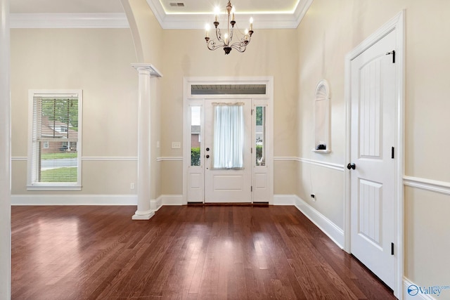 505 Barkley St SW, Hartselle, AL 35640 - foyer entrance featuring dark wood finished floors, ornate columns, crown molding, a chandelier, and arched walkways