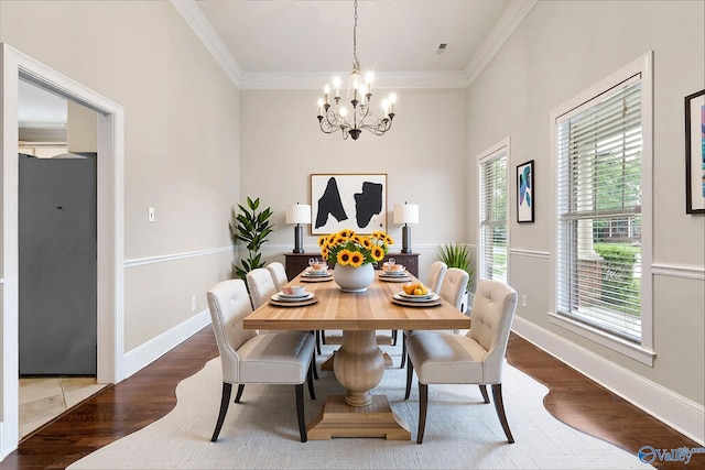 505 Barkley St SW, Hartselle, AL 35640 - dining room featuring wood finished floors, a chandelier, crown molding, and baseboards