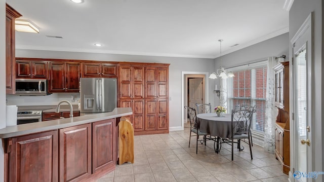 kitchen featuring appliances with stainless steel finishes, light countertops, a sink, visible vents, and a notable chandelier