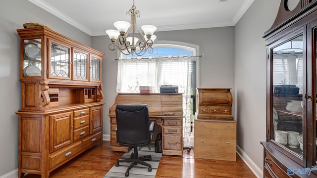 office area featuring a chandelier, baseboards, wood finished floors, and crown molding