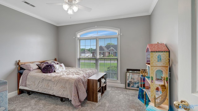 carpeted bedroom with crown molding, a ceiling fan, visible vents, and baseboards