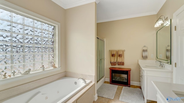 bathroom with vanity, ornamental molding, a glass covered fireplace, a stall shower, and a tub with jets