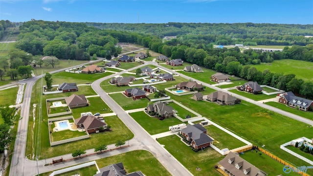 bird's eye view featuring a residential view and a wooded view