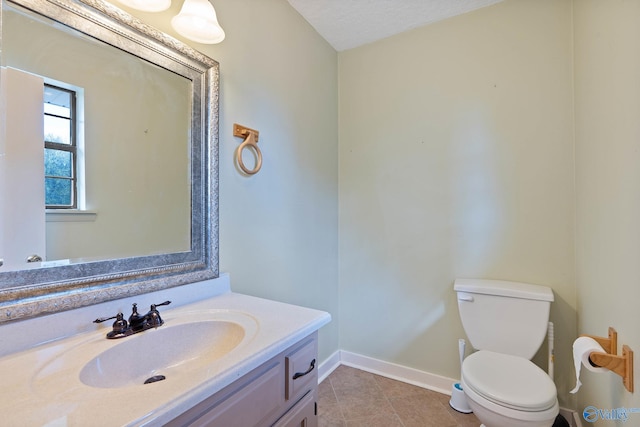 bathroom with tile patterned floors, a textured ceiling, vanity, and toilet