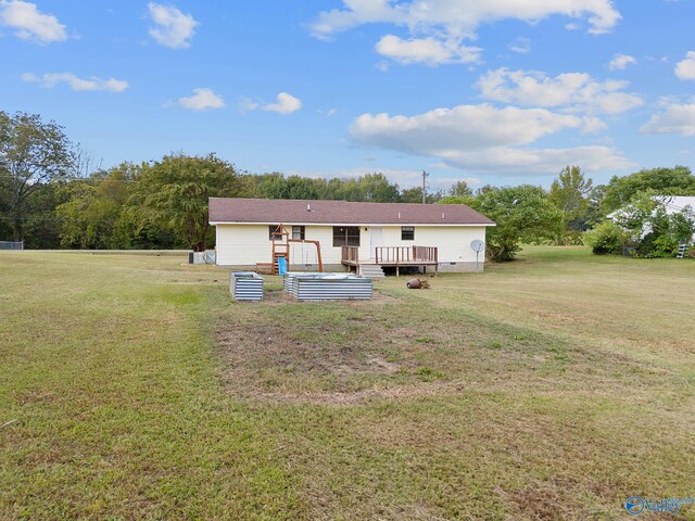 manufactured / mobile home with a wooden deck and a front lawn