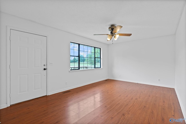 spare room with ceiling fan and hardwood / wood-style floors