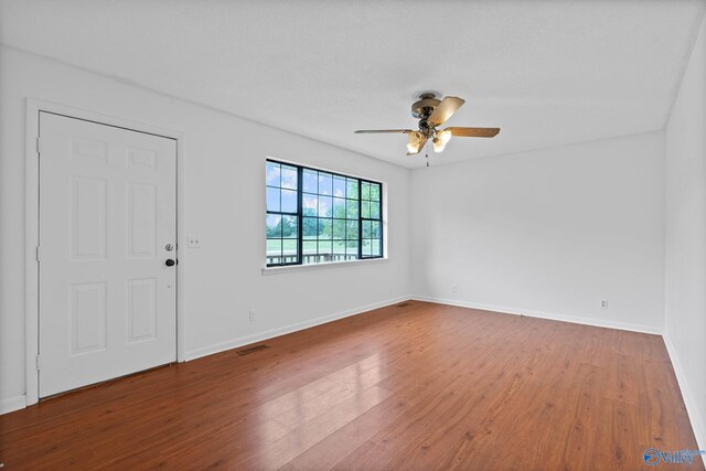 unfurnished room with wood-type flooring and ceiling fan