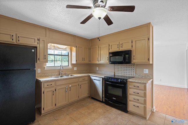 kitchen with light hardwood / wood-style floors, a textured ceiling, black appliances, ceiling fan, and sink