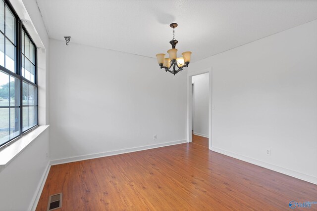 empty room featuring light wood-type flooring, ceiling fan, and a textured ceiling