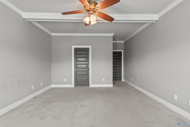 unfurnished bedroom featuring carpet floors, ornamental molding, baseboards, and ceiling fan