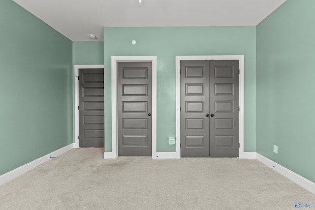 unfurnished bedroom with carpet and baseboards