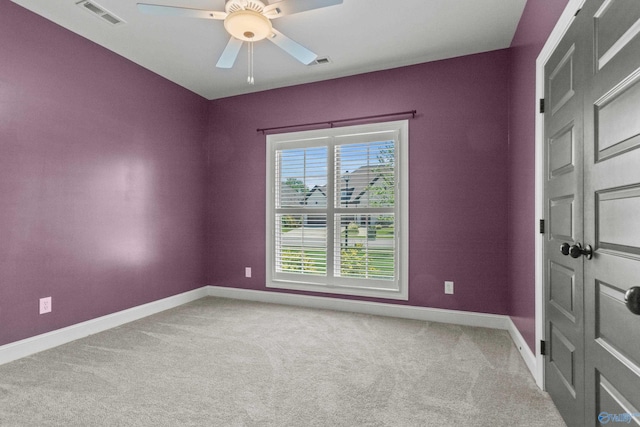 unfurnished room with baseboards, carpet flooring, and ceiling fan