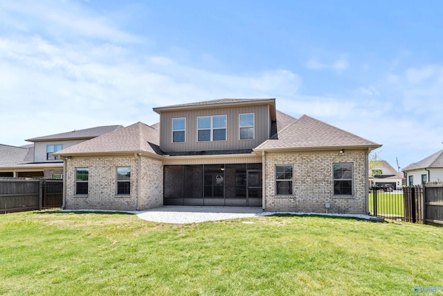 rear view of house featuring a sunroom, brick siding, a patio, and ceiling fan