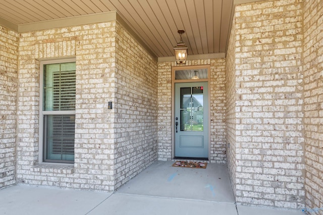 property entrance featuring brick siding