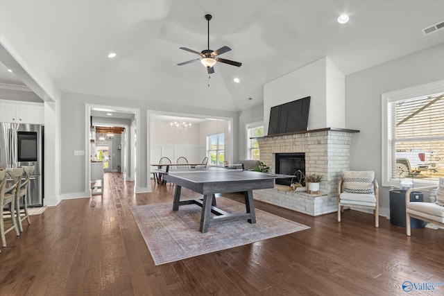 111 Starling Dr, Madison, AL 35756 - game room featuring a brick fireplace, dark wood-type flooring, visible vents, and ceiling fan with notable chandelier