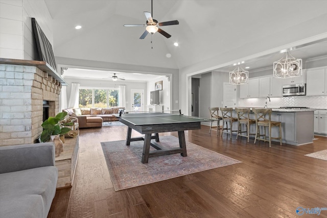 111 Starling Dr, Madison, AL 35756 - recreation room featuring recessed lighting, ceiling fan with notable chandelier, a fireplace, high vaulted ceiling, and dark wood finished floors