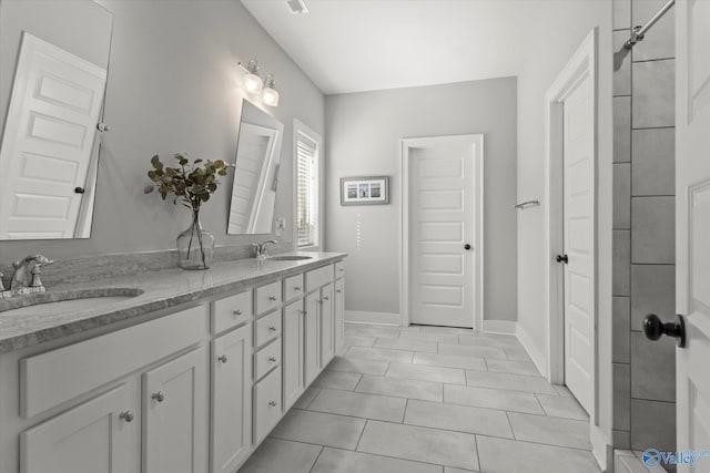 111 Starling Dr, Madison, AL 35756 - bathroom featuring double vanity, a sink, tile patterned floors, and baseboards