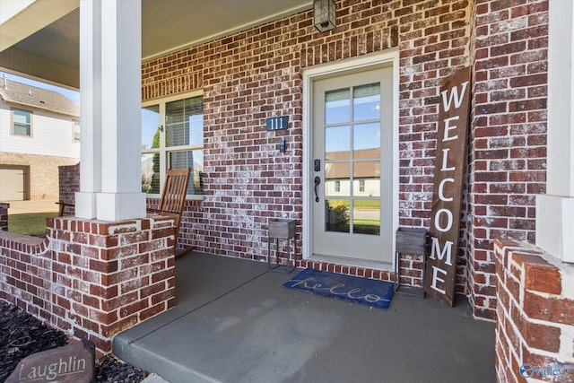 111 Starling Dr, Madison, AL 35756 - view of exterior entry featuring brick siding and a porch