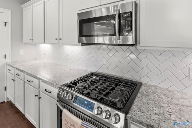 111 Starling Dr, Madison, AL 35756 - kitchen featuring tasteful backsplash, white cabinetry, stainless steel appliances, and dark wood-style flooring