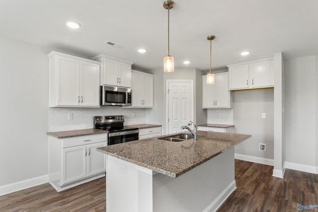 kitchen featuring white cabinetry, appliances with stainless steel finishes, sink, and dark stone counters