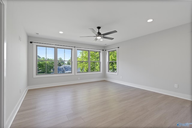 empty room featuring baseboards, a ceiling fan, wood finished floors, and recessed lighting