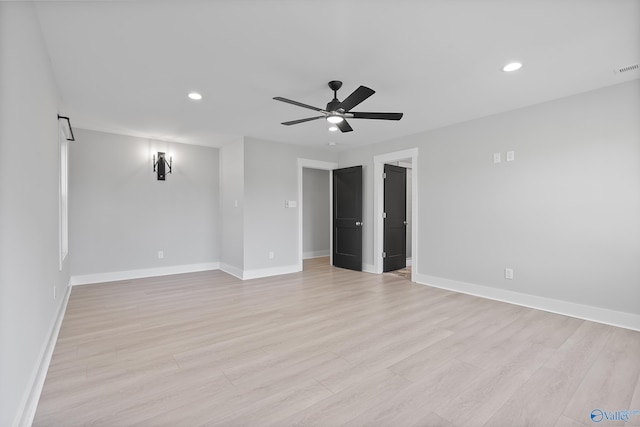 unfurnished room featuring baseboards, a ceiling fan, and light wood-style floors