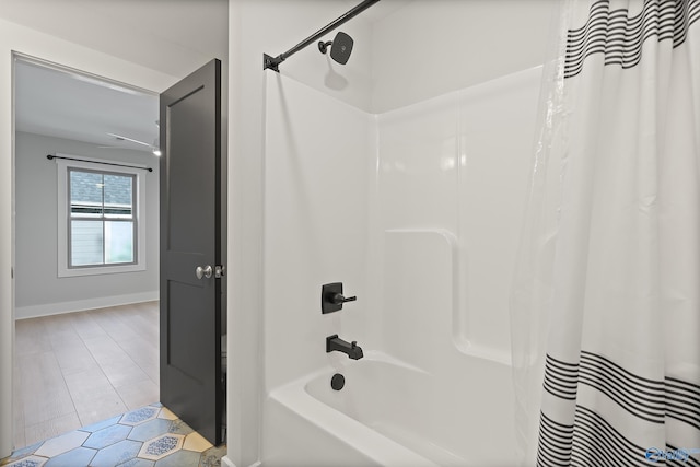 full bathroom with tile patterned flooring, baseboards, and shower / bathtub combination with curtain