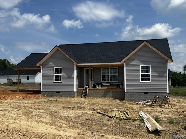 back of house featuring a porch, crawl space, and roof with shingles