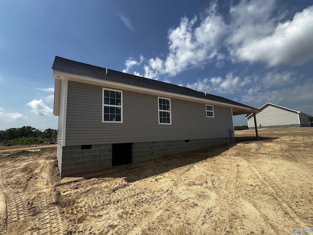rear view of property featuring crawl space