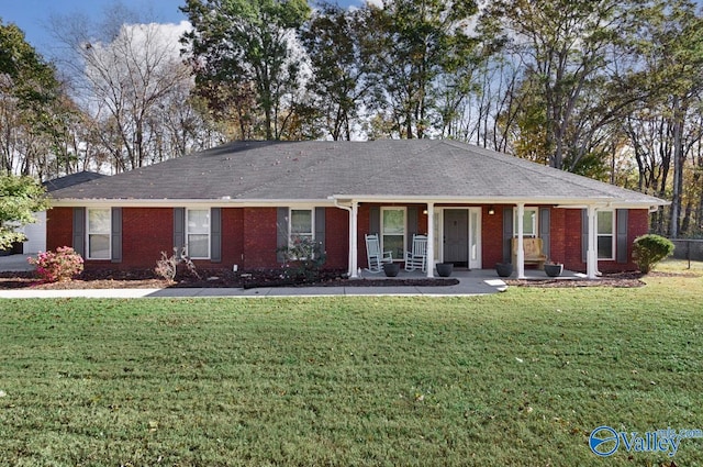 ranch-style house with covered porch and a front lawn