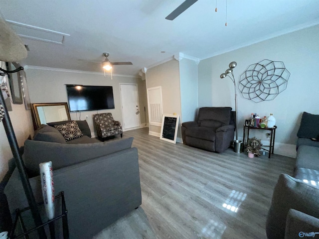 living room with crown molding, hardwood / wood-style floors, and ceiling fan