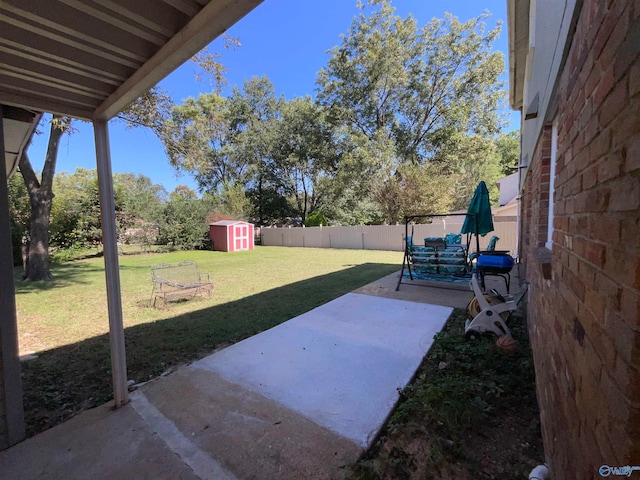 view of yard with a patio area and a storage shed