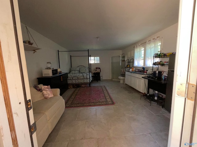 bedroom featuring light tile patterned flooring and multiple windows