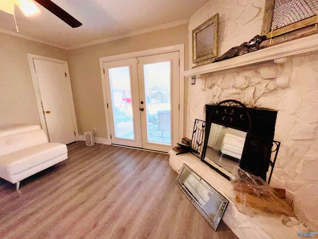 interior space with ornamental molding, french doors, hardwood / wood-style flooring, and ceiling fan