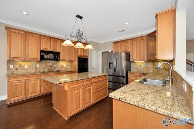 kitchen with black appliances, a sink, a kitchen island, dark wood finished floors, and light stone countertops