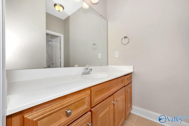 bathroom with tile patterned flooring, vanity, and baseboards