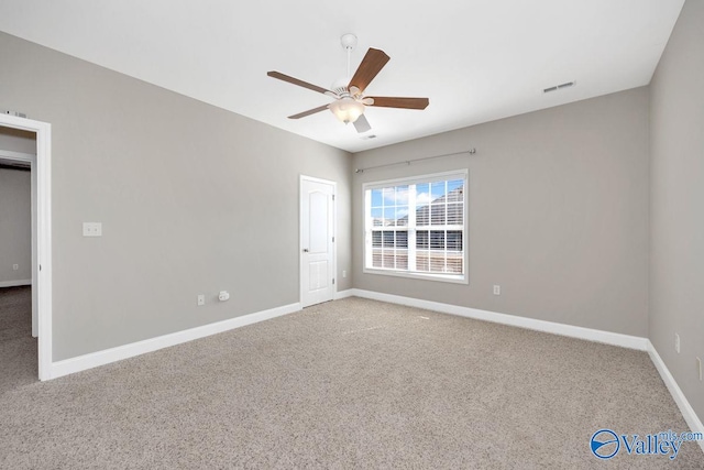 unfurnished bedroom with carpet flooring, visible vents, a ceiling fan, and baseboards