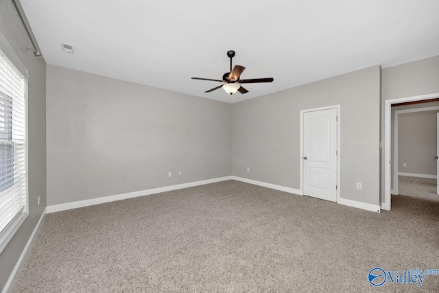 unfurnished bedroom featuring visible vents, ceiling fan, baseboards, and carpet