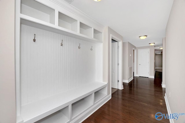 mudroom featuring visible vents, baseboards, and dark wood-style flooring